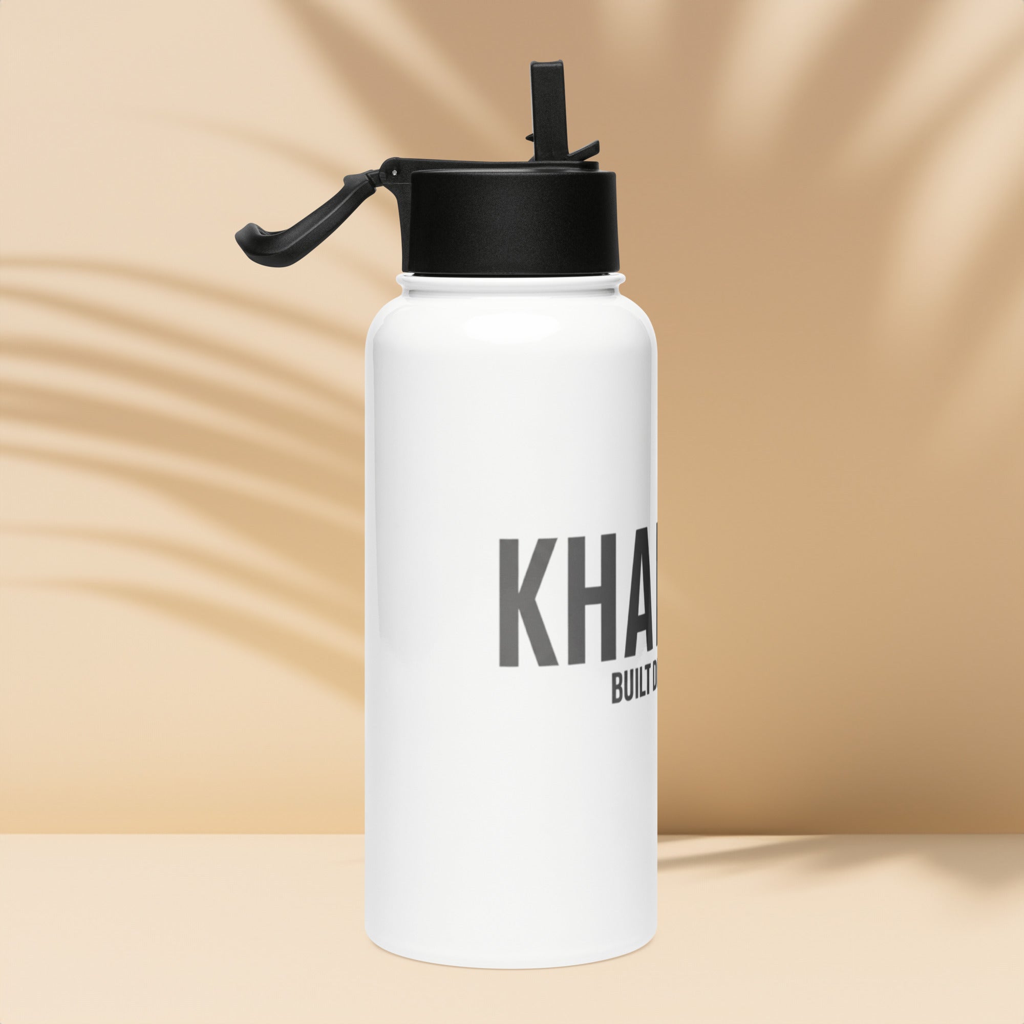 Side view of KHANAGE Collective branded water bottle with straw lid — NZ