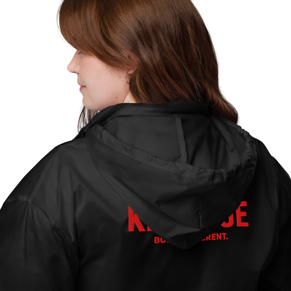 Rear view of KHANAGE Collective red logo unisex windbreaker — black