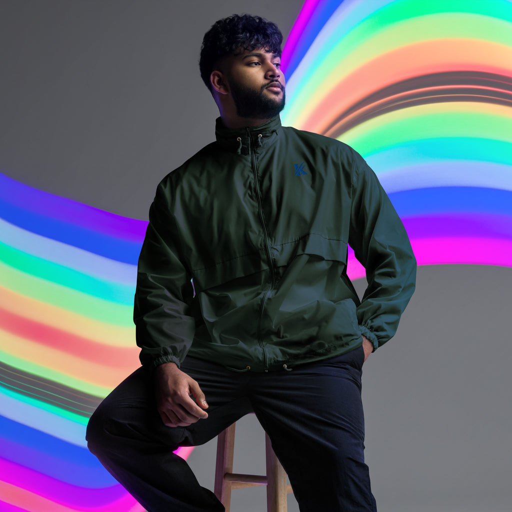 Front view of KHANAGE Collective cobalt blue logo unisex windbreaker — premium streetwear NZ