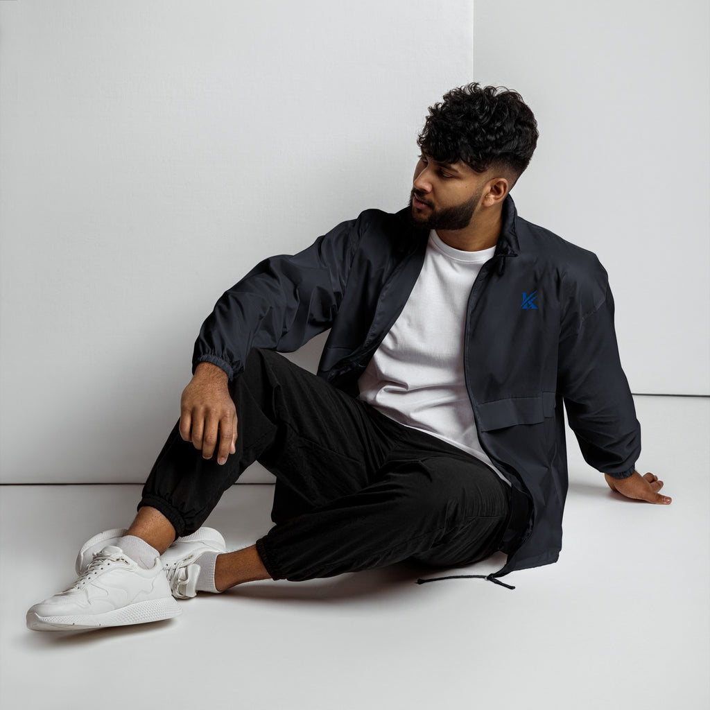 Front view of KHANAGE Collective cobalt blue logo unisex windbreaker — premium streetwear NZ